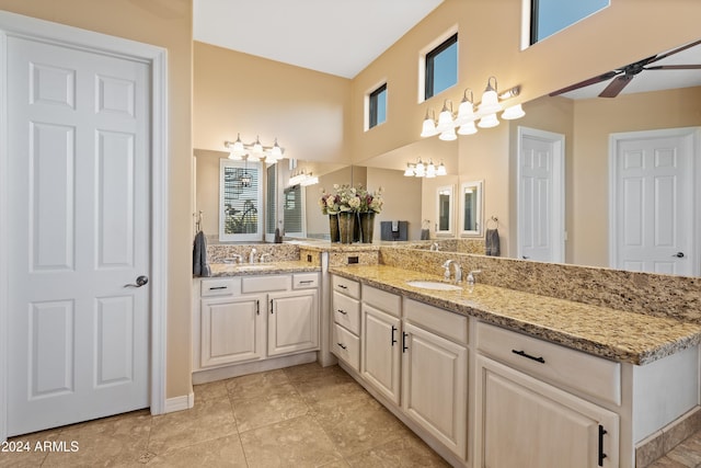 bathroom with ceiling fan, tile patterned flooring, and vanity