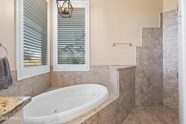 bathroom featuring a relaxing tiled tub