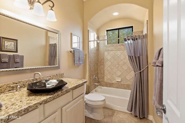 full bathroom featuring tile patterned floors, vanity, toilet, and shower / bath combo with shower curtain