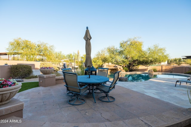 view of patio / terrace with a fenced in pool