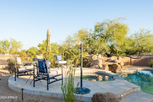 view of swimming pool featuring an in ground hot tub and a patio