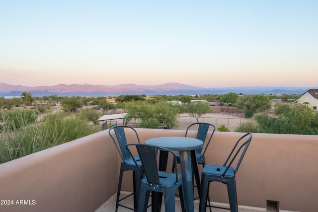 balcony at dusk with a mountain view