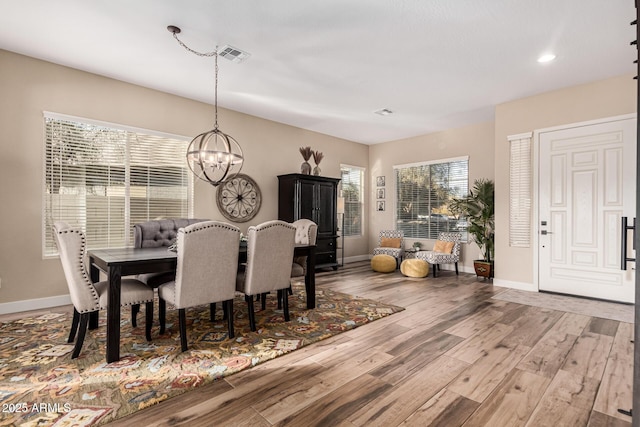 dining room with a chandelier and hardwood / wood-style floors