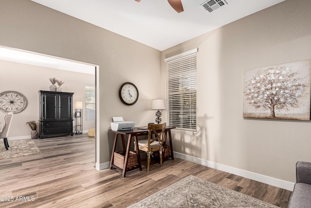 office with ceiling fan and hardwood / wood-style floors