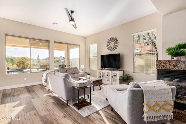 living room featuring hardwood / wood-style flooring and a tile fireplace