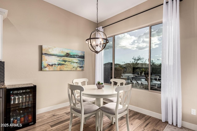 dining area with a wealth of natural light, wine cooler, and light hardwood / wood-style floors