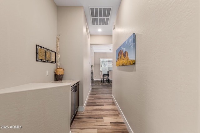 hall with hardwood / wood-style flooring