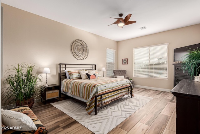 bedroom with ceiling fan and light hardwood / wood-style floors