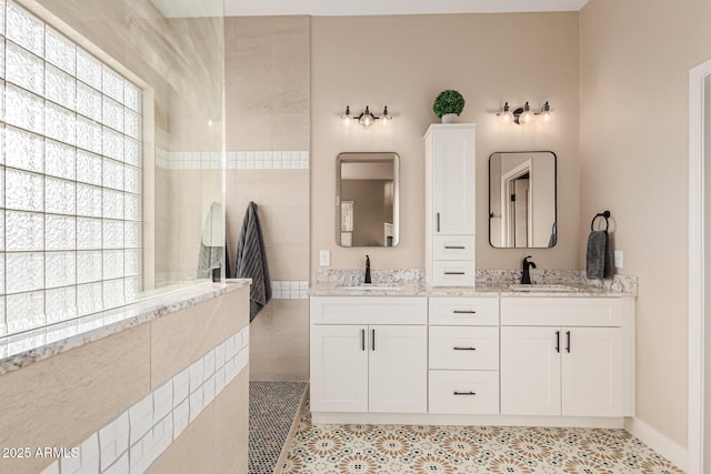 bathroom with vanity, a shower, tile patterned floors, and a healthy amount of sunlight