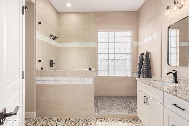 bathroom with vanity, tile patterned floors, and tiled shower