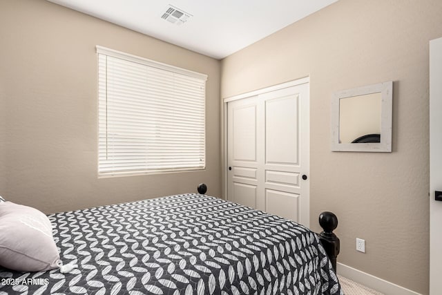 carpeted bedroom with a closet