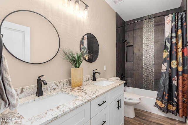 full bathroom featuring shower / bathtub combination with curtain, hardwood / wood-style floors, vanity, and toilet