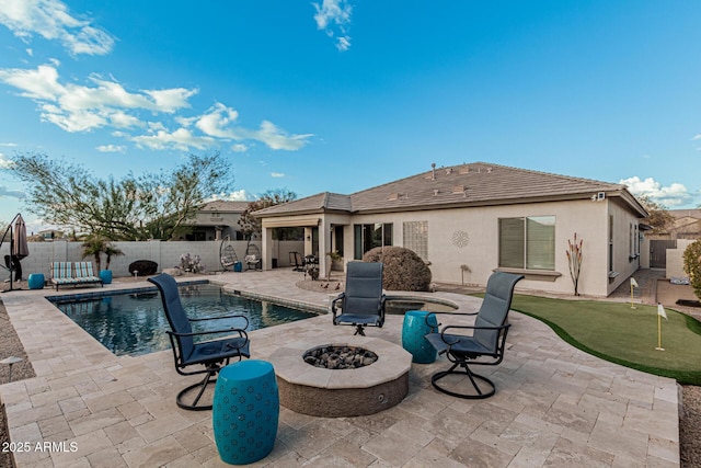 view of pool featuring a fire pit, a patio area, and a jacuzzi