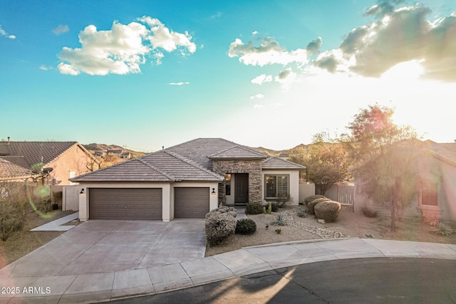 prairie-style house with a garage and a mountain view