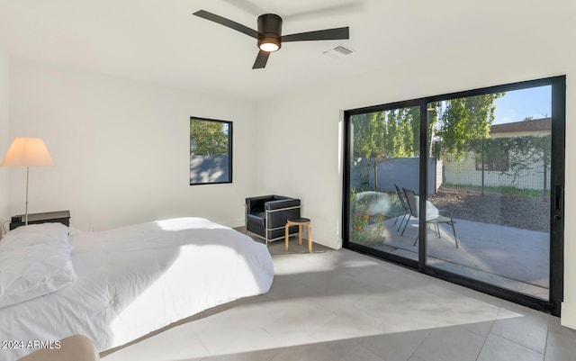 tiled bedroom with ceiling fan and access to exterior