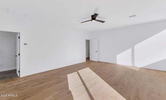 empty room featuring ceiling fan and light hardwood / wood-style flooring