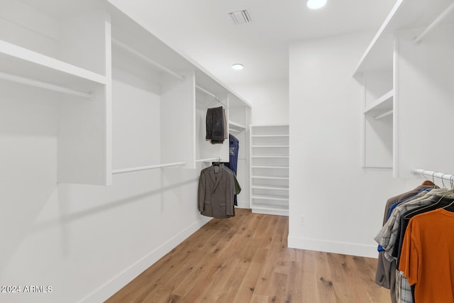 spacious closet featuring light hardwood / wood-style flooring