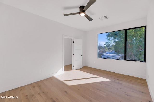 unfurnished bedroom with ceiling fan and light wood-type flooring