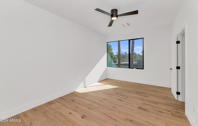 empty room featuring ceiling fan and light hardwood / wood-style flooring