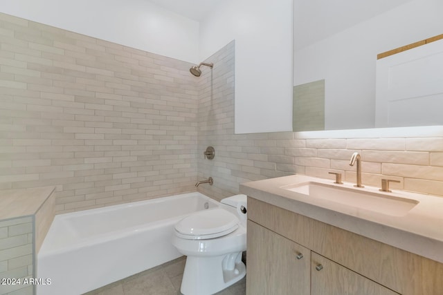 full bathroom featuring vanity, tiled shower / bath, tile patterned flooring, decorative backsplash, and toilet