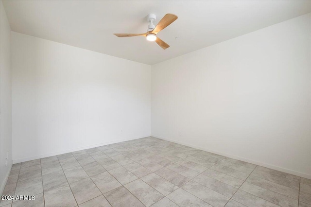 spare room with light tile patterned flooring and ceiling fan