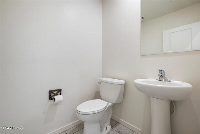 bathroom featuring toilet and tile patterned floors