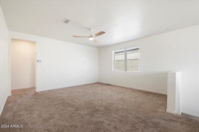 empty room with light colored carpet and ceiling fan