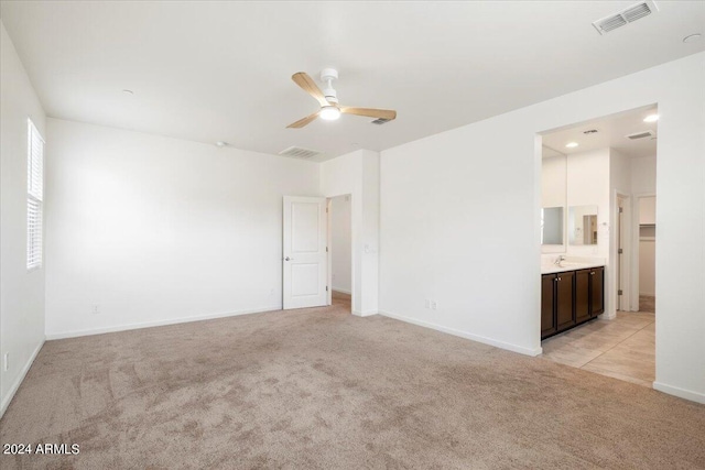 empty room with light carpet and ceiling fan