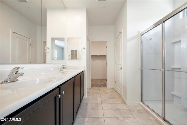 bathroom with walk in shower, tile patterned flooring, and dual bowl vanity