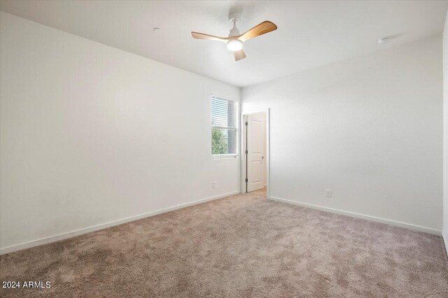 unfurnished room featuring light carpet and ceiling fan