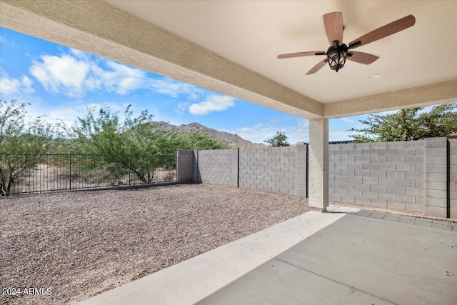 view of patio / terrace with ceiling fan and a mountain view