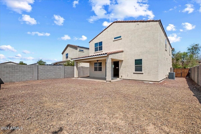 back of house with central air condition unit and a patio area