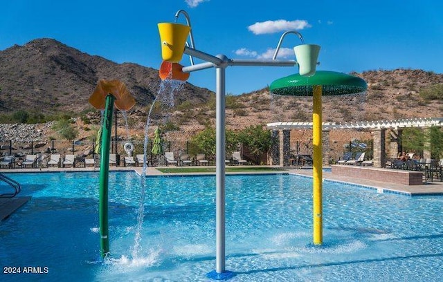 view of pool featuring pool water feature and a mountain view