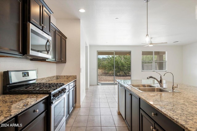 kitchen with ceiling fan, stainless steel appliances, sink, dark brown cabinetry, and light tile patterned floors