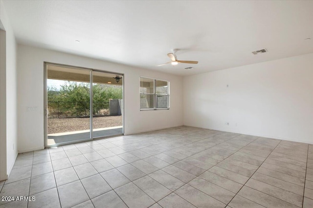 tiled spare room featuring ceiling fan