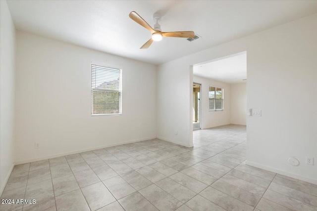 unfurnished room featuring ceiling fan and light tile patterned floors