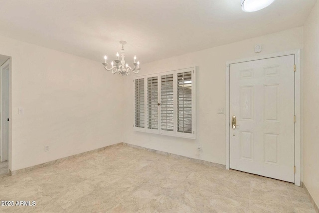 spare room featuring a chandelier