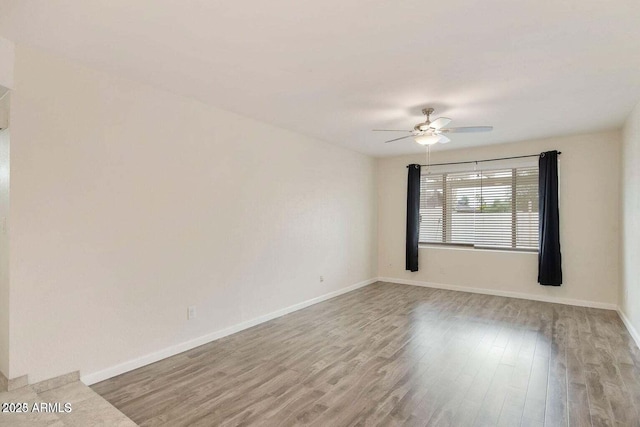 spare room featuring ceiling fan and light hardwood / wood-style floors