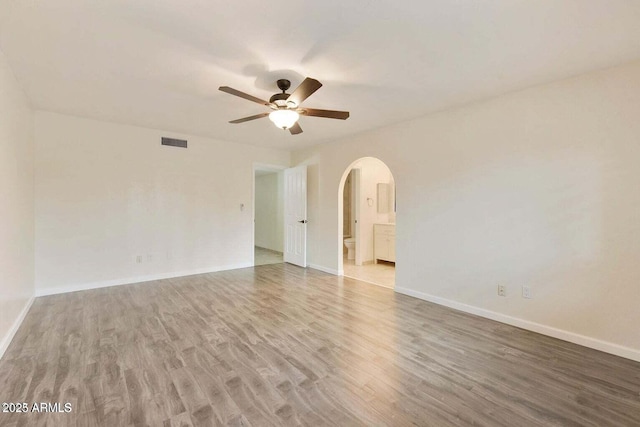 spare room featuring hardwood / wood-style floors and ceiling fan