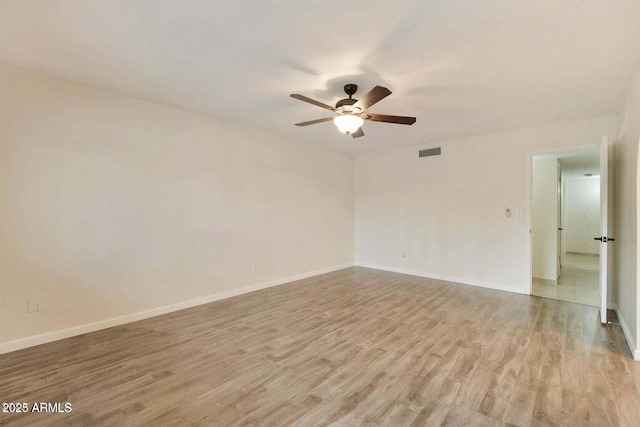 spare room with light hardwood / wood-style floors and ceiling fan