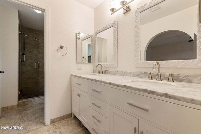 bathroom featuring vanity and an enclosed shower