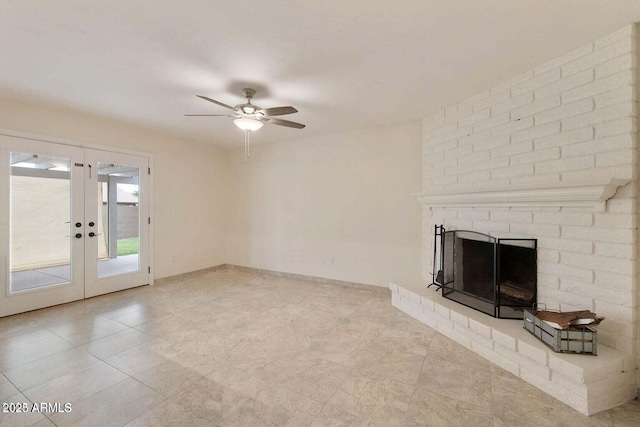 unfurnished living room featuring french doors, ceiling fan, and a brick fireplace