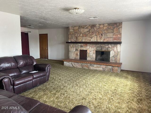 1010 N Florida Ave, Douglas, AZ 85607 - living area featuring carpet, a fireplace, and a textured ceiling