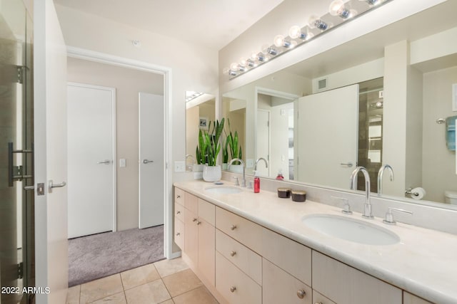 bathroom featuring toilet, tile patterned floors, and vanity