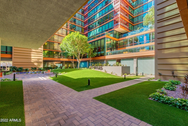 view of community featuring a patio area and a lawn