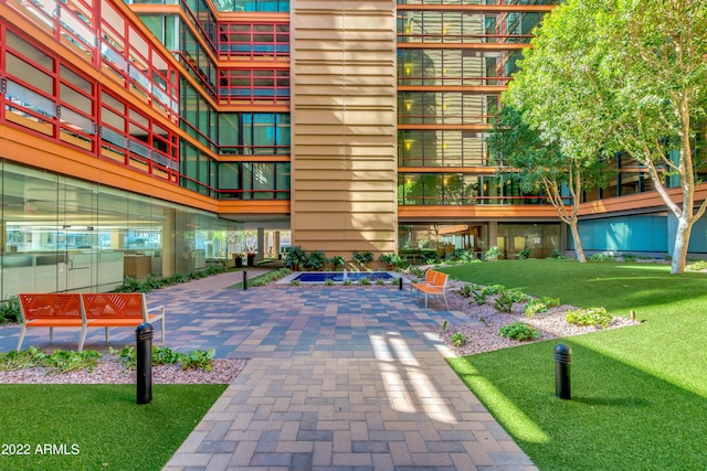 view of community featuring a yard and a patio