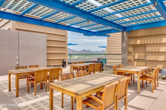 view of patio / terrace with a pergola and a mountain view