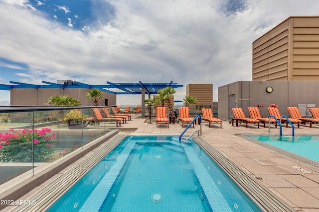 view of pool with a pergola and a patio