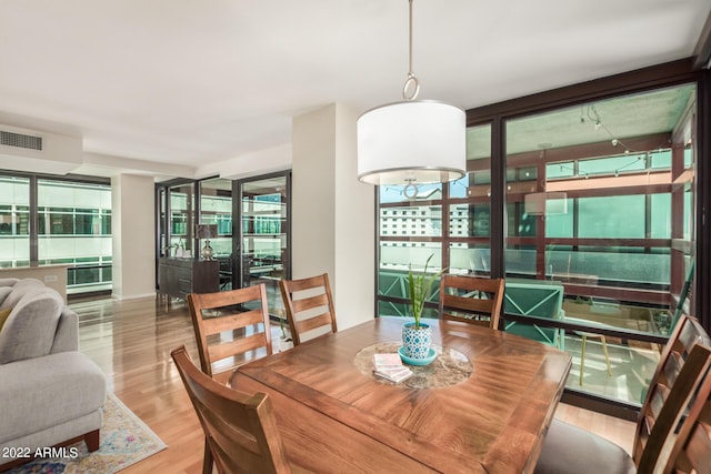 dining space with light hardwood / wood-style flooring