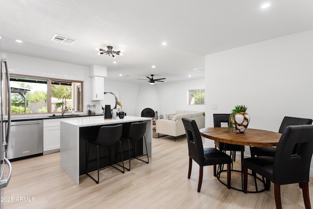 dining room with ceiling fan, healthy amount of natural light, light wood-style flooring, and recessed lighting